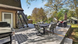A deck with outdoor furniture, a grill, and a staircase leading to a house. - Infrared Sauna, Firepit, Kayaks, Walk 2 Launch, Authentic WI Lake Life (Poynette)