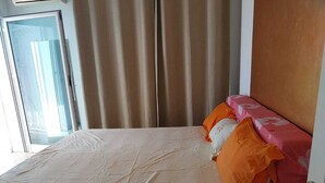 A hotel room with a bed, curtains, a window, and a door. - Luxury & Fully Equipped | Safe & Terrace | All Amenities within Walking Distance (Tunis)