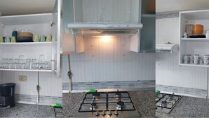 A kitchen with white cabinets, a gas stove, and a coffee maker. - Luxury & Fully Equipped | Safe & Terrace | All Amenities within Walking Distance (Tunis)