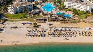 An aerial view of a resort with multiple swimming pools, beach umbrellas, and beachfront accommodations. - Sentido Marillia Hammamet  (Hammamet)