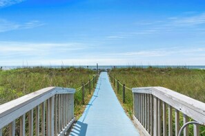 A pathway leading to a beach with wooden railings on both sides. - Oceanfront Buena Vista 703- 2BR- Outdoor Pool (North Myrtle Beach)