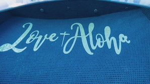A blue tiled floor with the words 'Love & Aloha' written in cursive.