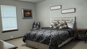 A bedroom with a bed, a ceiling fan, a window with blinds, and a framed picture on the wall. - Family and Pet Friendly Home in Benton, AR (Benton)