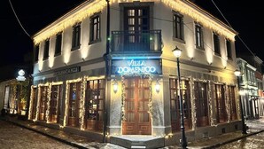 A building with a sign reading 'Villa Domenico' and a balcony. - Villa Domenico Korce Old Bazaar (Korçë)