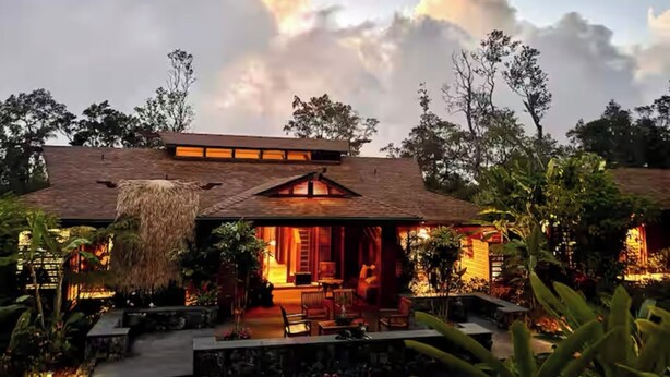 A house with a thatched roof, a porch with chairs, and a garden. - Cloud 9, Hawaiian  Forest Retreat
Get away from it all, but close to everything. (Kailua-Kona)
