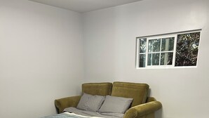 A room with two beds, a sofa, and a window. - Secret garden in center of LA, 3mi Sofi, 4 mi LAX, 6 mi beach, pets welcome (Los Angeles)
