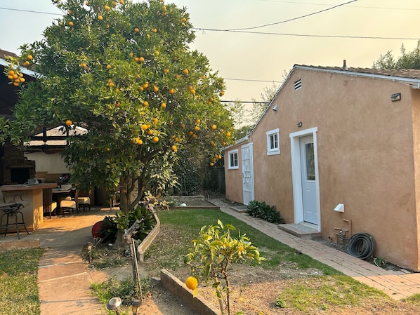 A residential property with a garden, a patio, and a small outdoor seating area.