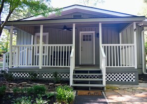 A house with a porch, a door, and a small garden area.
