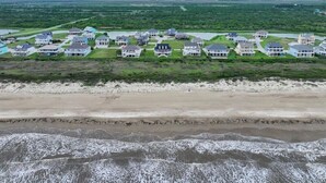 A coastal residential area with houses, a beach, and a view of the ocean. - Probably The Best View on the Peninsula (Bolivar Peninsula)