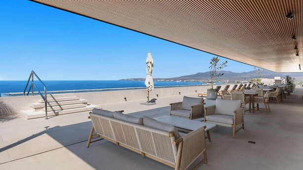 A rooftop terrace with outdoor seating, a staircase, and a view of the ocean. - Oceanview 2BR Near Beach + Golden Zone Rooftop (Bucerías)