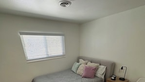 A bedroom with a bed, a nightstand, a lamp, a window, and a door. - Napa Home 10 Minutes from BottleRock & Downtown (Napa)