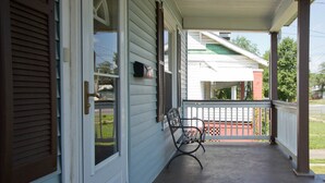 A porch with a bench, a mailbox, and a door with shutters. - Welcome to the Blue Oasis! Come stay with us in our fully furnished 4-bedroom (Roanoke)