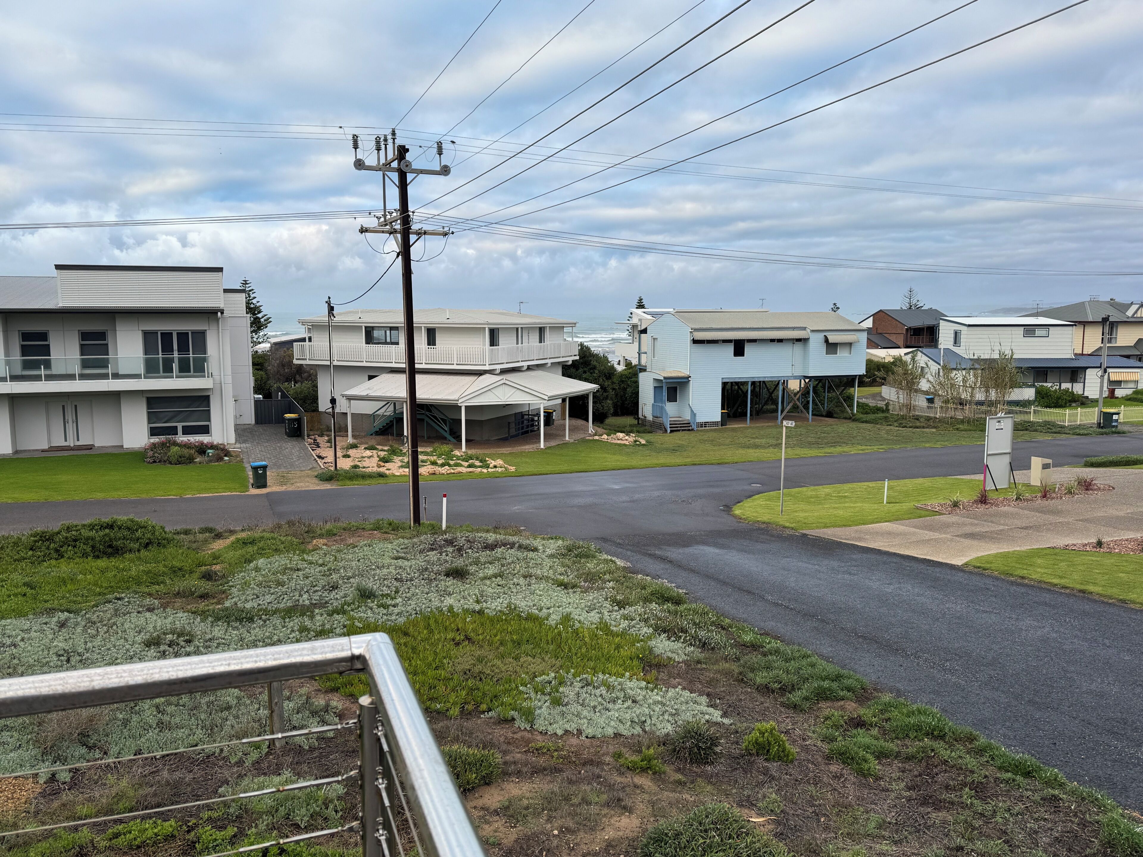 A residential area with houses, a clear sky, and a road.