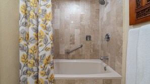 A bathroom with a bathtub, a showerhead, a handrail, and a towel rack. - Ocean View 2BR Condo at Princesa de Peñasco – Beautiful Balcony view C403 (Puerto Peñasco)