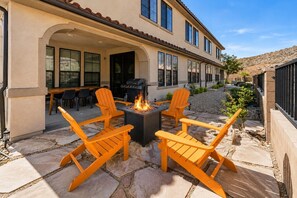 A patio with outdoor seating and a fire feature.