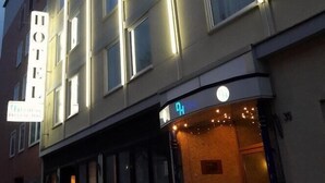 A multi-story hotel with a prominent 'HOTEL' sign, a ground-level entrance, and a visible elevator. - City Hotel Deutsches Haus (Hagen)