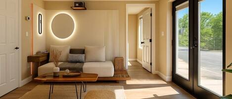 A modern living room with a sofa, coffee table, and a large window.