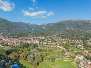 A town nestled in a valley with a mountain backdrop, featuring a mix of residential buildings and green spaces. - Casale 180 by Interhome (Camaiore)