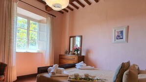 A bedroom with a bed, a dresser, a mirror, and a window. - Alla Collina Del Sole by Interhome (Ciciana)