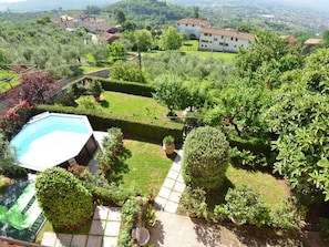 A residential area with a swimming pool, well-maintained gardens, and houses with red-tiled roofs. - Alla Collina Del Sole by Interhome (Ciciana)