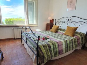 A bedroom with a bed, a window, a radiator, and a lamp. - Podere San Martino by Interhome (Buti)