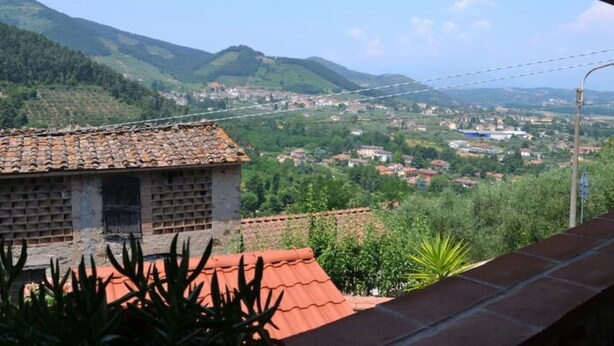 A view from a balcony overlooking a valley with houses and mountains. - Casa Max by Interhome (Capannori)