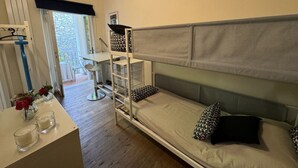 Una habitación con literas, un escritorio y una silla.