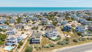 A coastal residential area with houses, a road, and a beach. - Seabreeze at Ocean Hill: New to Rental Program, Private Pool & Hot Tub, Dog-Friendly (Corolla)