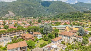 A residential area with houses and a mountain in the background. - Orto Degli Olivi Proprietà by Interhome (Camaiore)