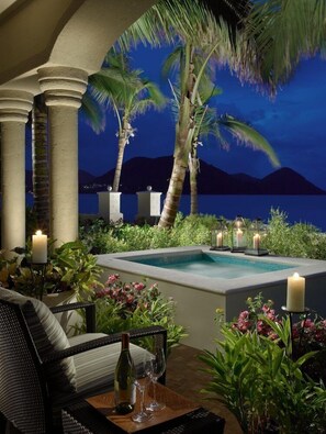 A poolside area with a view of the sea, palm trees, and a night sky. - The Landings St Lucia Resort And Spa Ex Elegant Hotels (Gros Islet)