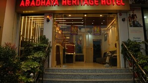 The Aradhaya Heritage Hotel entrance with a reception area, a staircase, and a sign indicating foreign currency acceptance. - Aradhaya Heritage Hotel (Bodh Gaya)