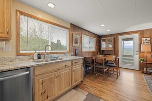 Enjoy cooked meals with loved ones on snowy days with this cozy dining room/kitchen combo.