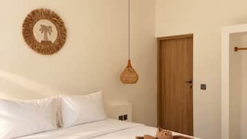 A bedroom with a bed, a ceiling fan, a wall-mounted light, and a door.