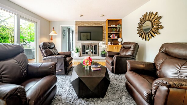 A living room with leather sofas, a coffee table, and a fireplace. - Luxury & Private 6BR Single House • Summer Retreat w/ Parking & Pet-Friendly 35 (Randolph)
