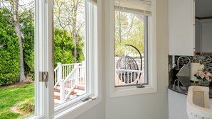 A kitchen with a white countertop, a sink, and a window overlooking a deck. - Luxury & Private 6BR Single House • Summer Retreat w/ Parking & Pet-Friendly 35 (Randolph)