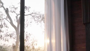 A room with a large window, wicker chairs, and a view of trees. - Baan Rim Doi Maerim (Mae Rim)