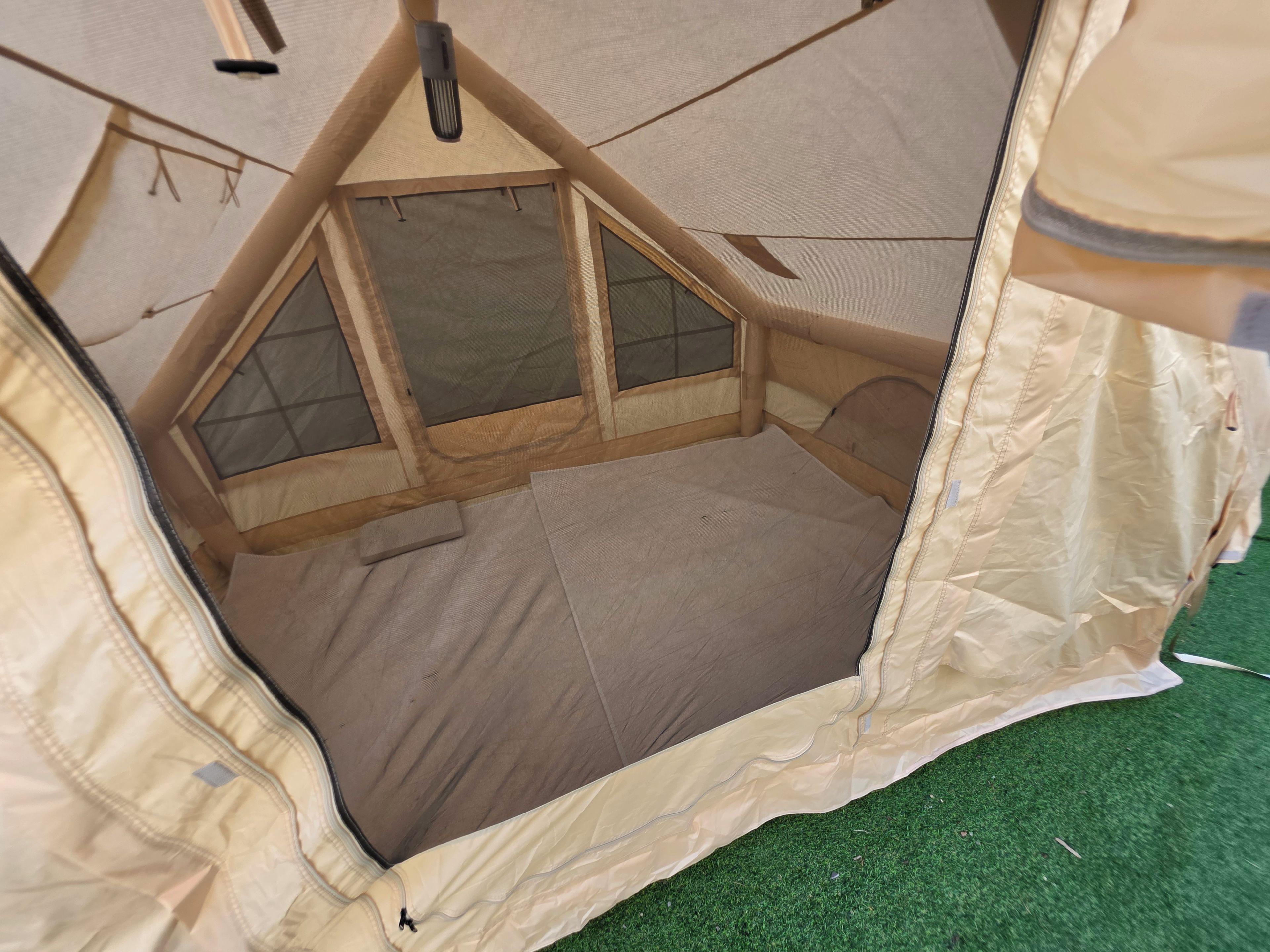 A tent with a triangular entrance and a window.