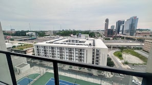 A multi-story building with a flat roof, surrounded by roads and other buildings. - Luxury High-Rise Condo w/ City Views Marta Bus & Train Access Free Parking (Atlanta)