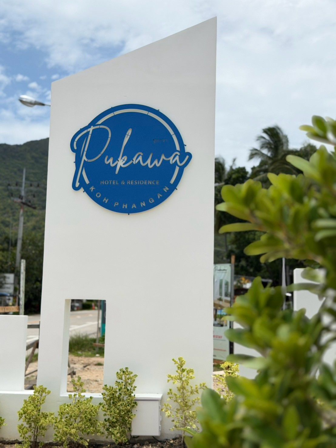 A sign for 'Pukawa Hotel & Residence' with a circular logo and text.