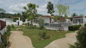 A resort with multiple villas, a central pool area, and a well-maintained garden. - Pukawa Hotel & Residence (Ko Pha-ngan)