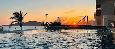 Outdoor pool, open 10:00 AM to 10:00 PM, pool umbrellas, pool loungers