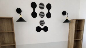 Une chambre à coucher avec un lit, deux tables de chevet, une échelle en bois et des lampes fixées au mur.