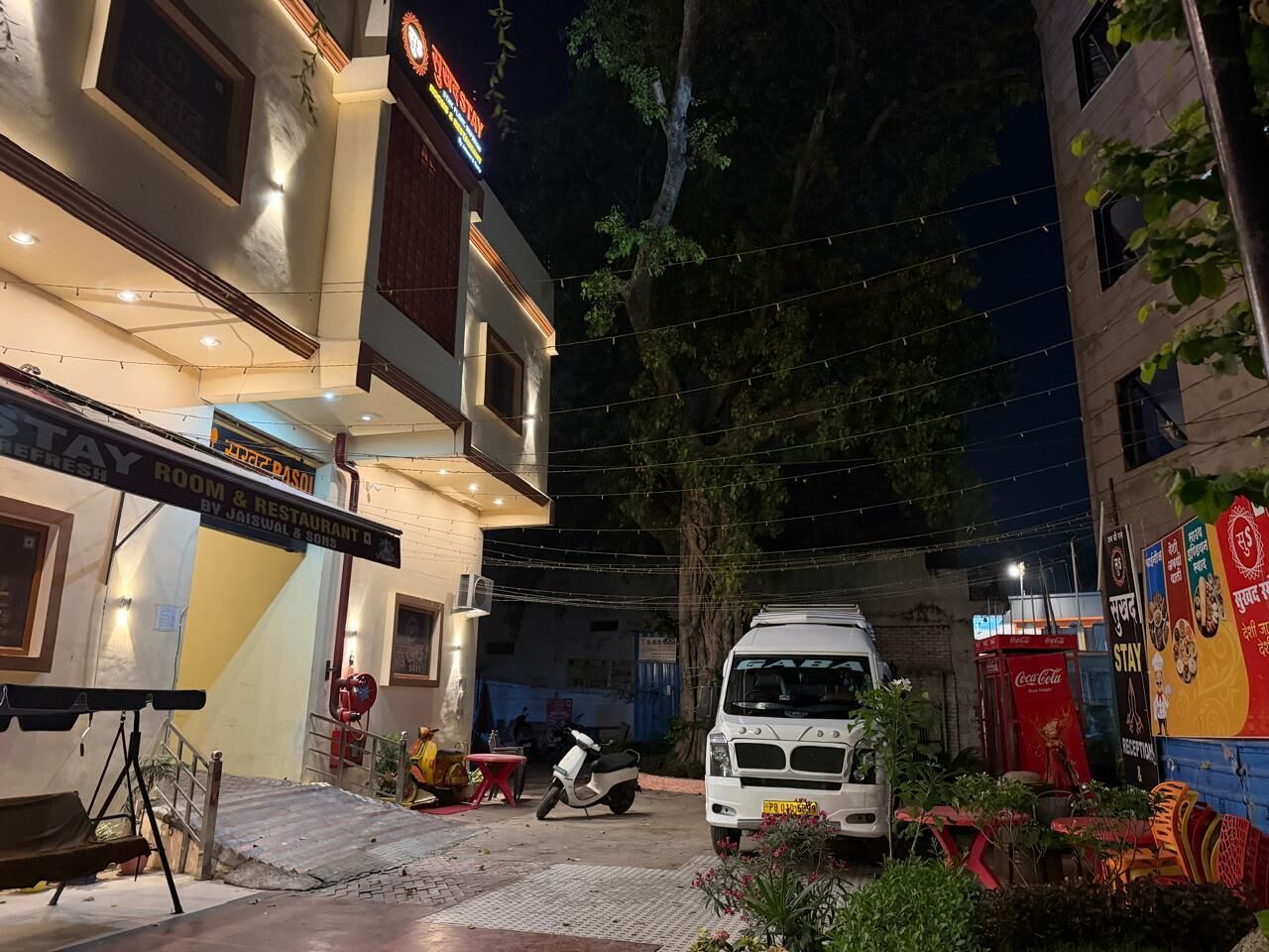 A building with a sign for a restaurant and a parked vehicle.