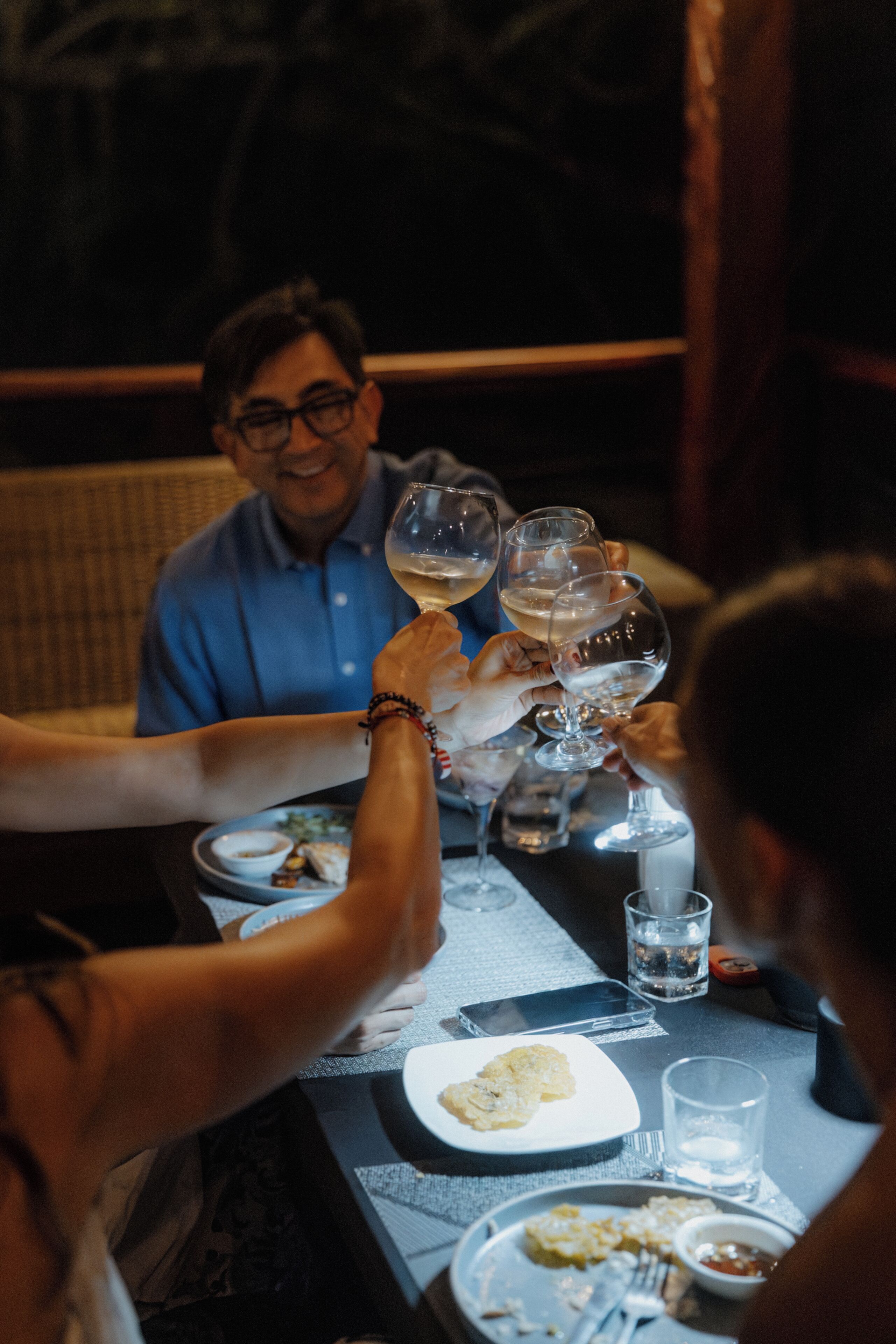 A dining table with plates, glasses, and cutlery.