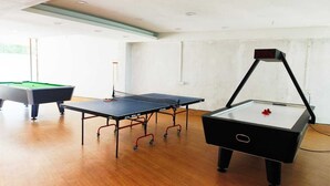 A room with a pool table, a ping pong table, and a foosball table. - Silverador Resort Club (Mira Bhayandar)