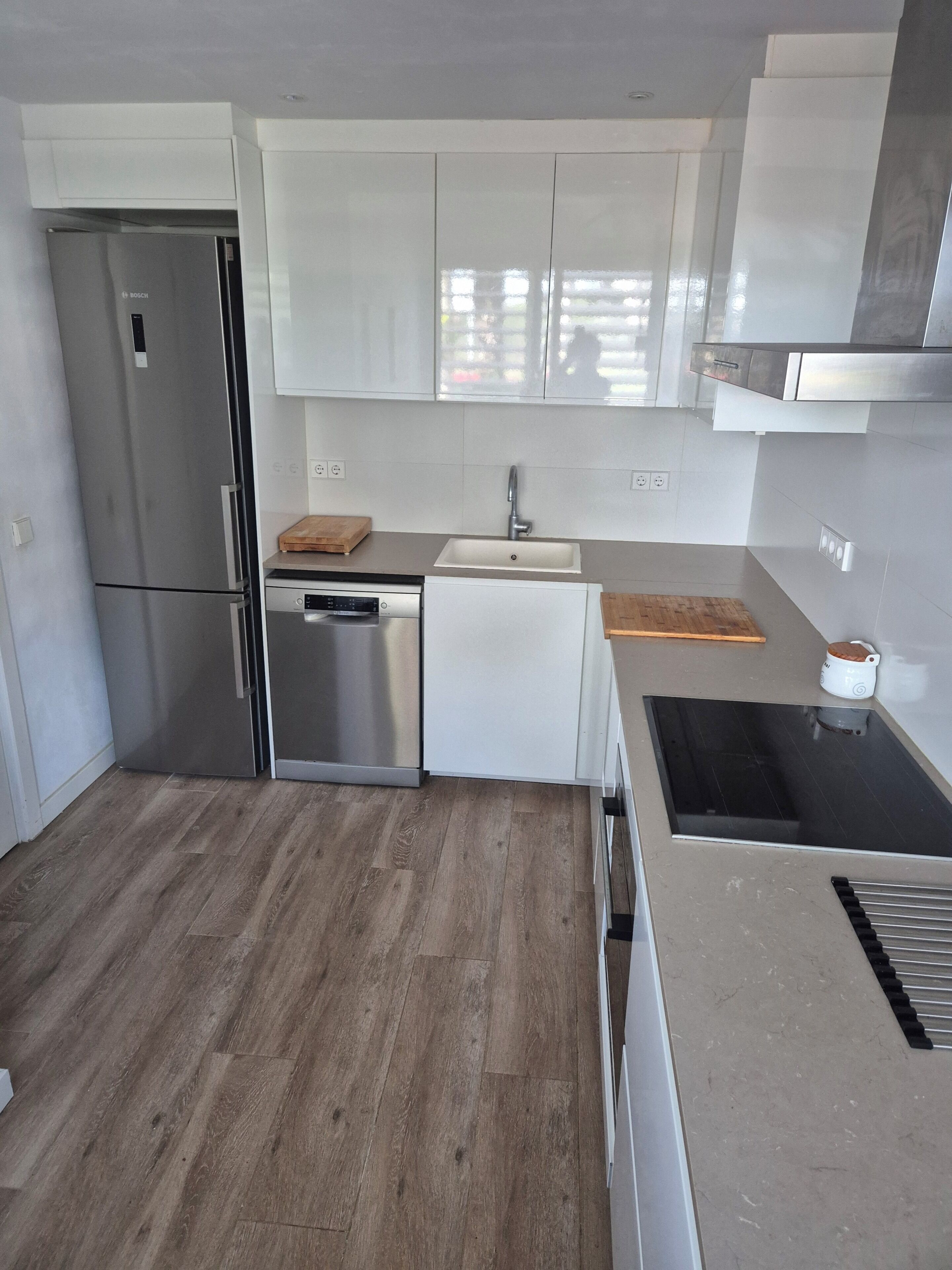 A modern kitchen with stainless steel appliances, a dishwasher, and a sink.
