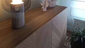 A modern room with a wooden desk, a wall-mounted light, a decorative coral piece, and a potted plant. - Villa Bénédictins (Limoges)