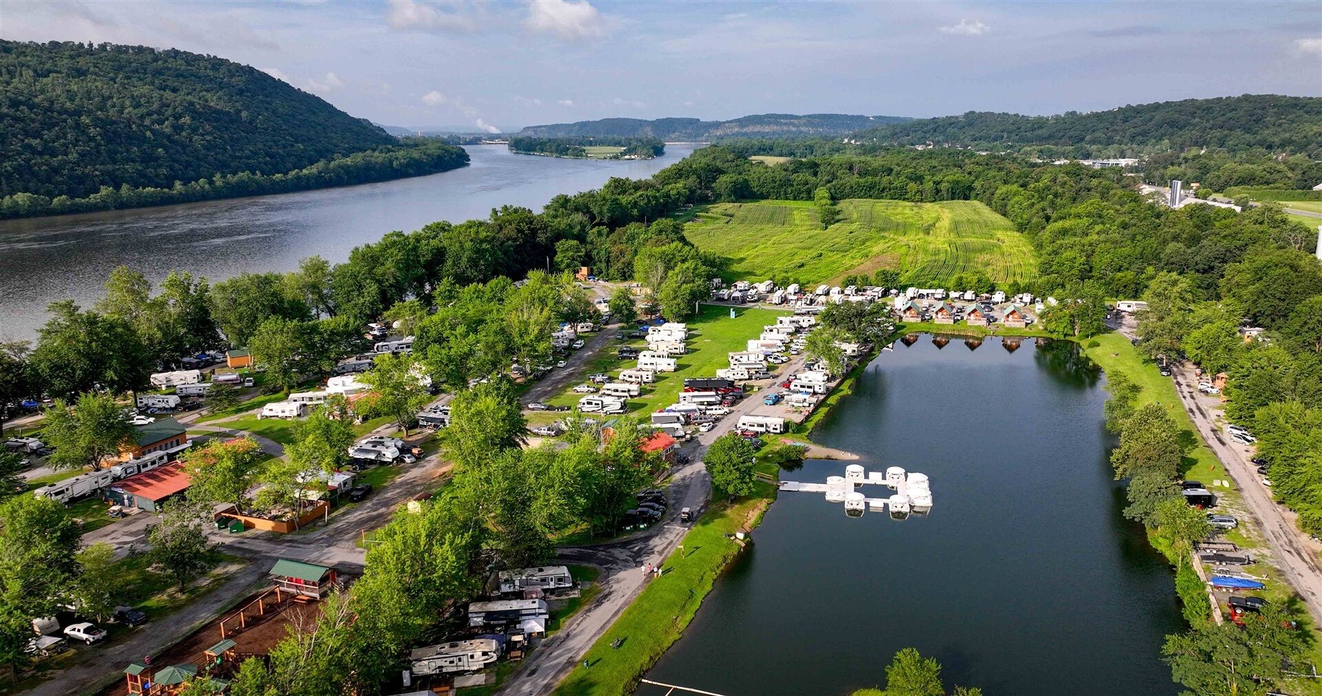 A lakeside RV park with multiple campsites and a dock.