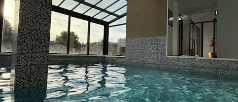 Indoor pool, outdoor pool, open noon to 8:00 PM, pool umbrellas