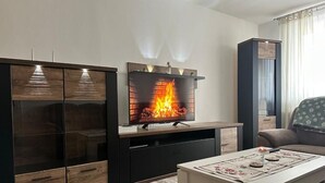 A modern living room with a fireplace, a sofa, and a coffee table.